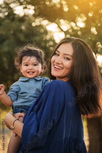 Mother Holding Her One Year Old Son in Nature photo