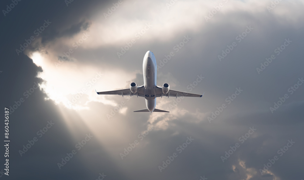 White passenger airplane flying in the sky amazing clouds in the background - Travel by air transport White passenger airplane flying in the sky amazing clouds in the background - Travel by air transport