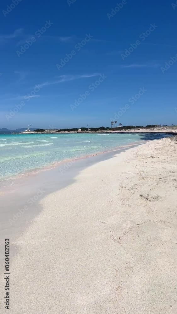 Vertical video. White sand beach on a narrow strip of land on Formentera. Blue famous beach with people relaxing on vacation in the mediterranean sea with luxury vessels and boats. Turquoise sea. Vertical video. White sand beach on a narrow strip of land on Formentera. Blue famous beach with people relaxing on vacation in the mediterranean sea with luxury vessels and boats. Turquoise sea.