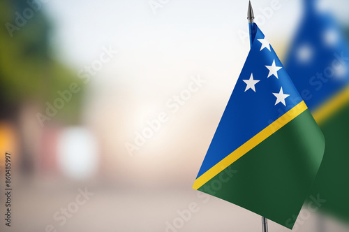 Small flags of Solomon Islands on a blurred background photo