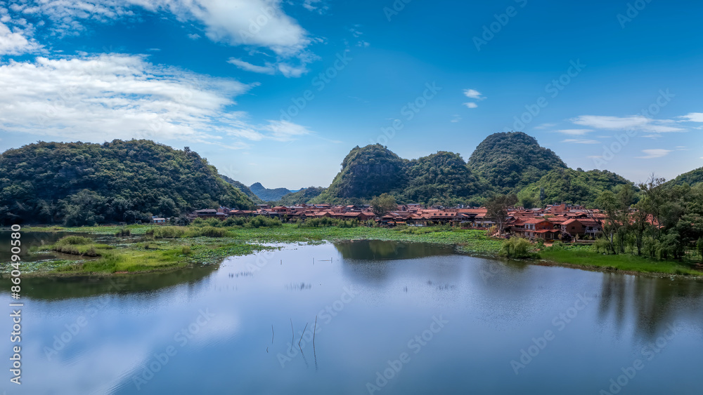 Fototapeta premium Serene Village Landscape by the Lake