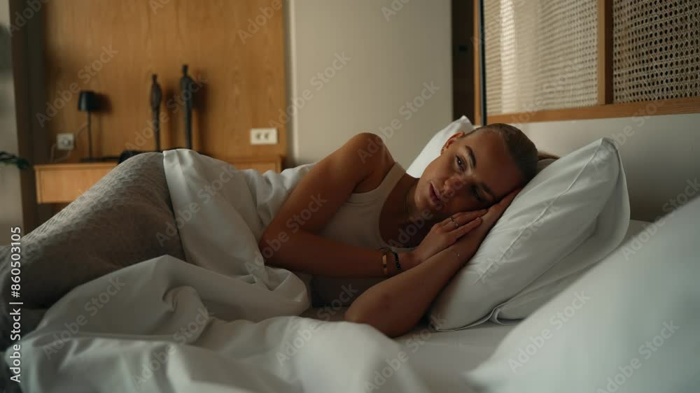 Beautiful blonde woman waking up in the morning in the bedroom Beautiful blonde woman waking up in the morning in the bedroom