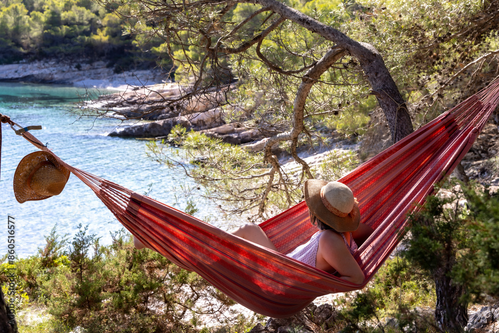Woman in a hammock in Stupica Bay on the island of Zirje in Croatia
