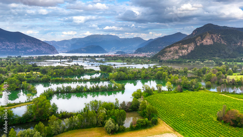 Fototapeta Naklejka Na Ścianę i Meble -  Aerial view of the National Reserve of Peat Bogs with lake Iseo in the background, Franciacorta, Lombardy, Italy