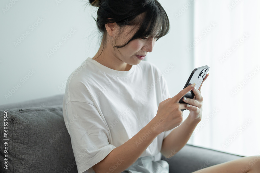 Asian woman using smart phone spending time checking news social media cell telephone technology e-commerce Asian woman using smart phone spending time checking news social media cell telephone technology e-commerce
