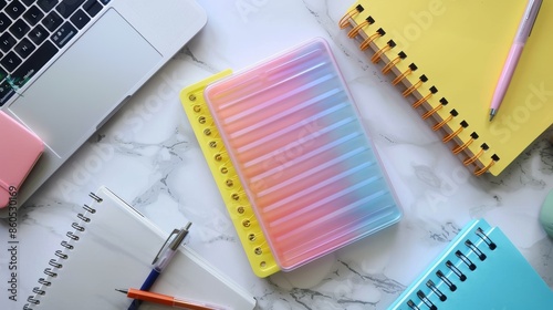 Colorful Office Supplies on Marble Desk with Laptop and Notebooks