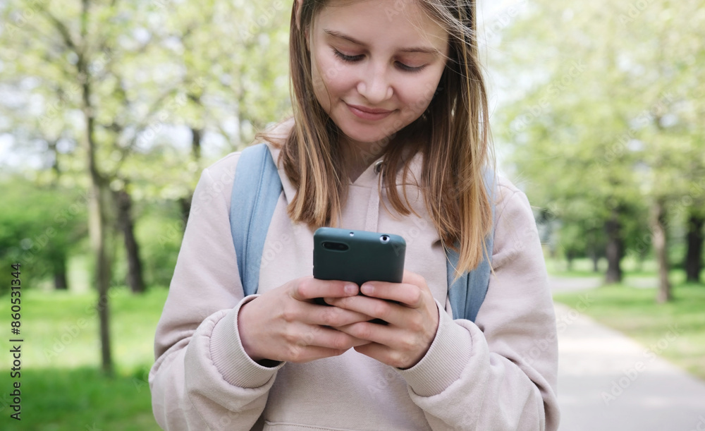 Adorable Small Girl Using A Smartphone In The Park Adorable Small Girl Using A Smartphone In The Park