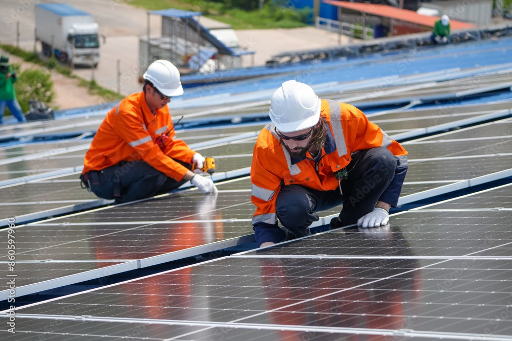 Technology solar cell, Engineer service and workers installation solar cell on the roof of factory industry. technician inspection and repair solar cell on the roof of factory Technology solar cell, Engineer service and workers installation solar cell on the roof of factory industry. technician inspection and repair solar cell on the roof of factory