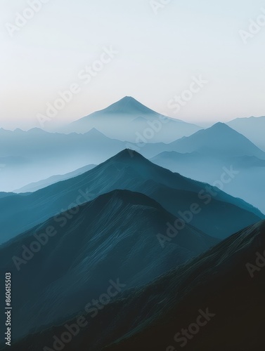 A serene view of blue mountains layered under the soft morning mist, exemplifying tranquility and natural beauty.