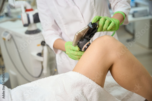Clinic employee uses a dermatoscope with a mobile application