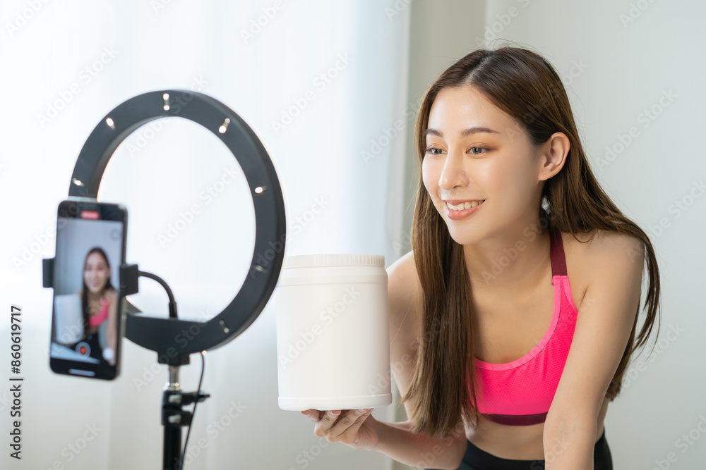 Vlogger asian young woman blogger, influencer showing product of health care, using smart mobile phone live selling food replacement, weight lose. Show goods to customer, present, streaming online. Vlogger asian young woman blogger, influencer showing product of health care, using smart mobile phone live selling food replacement, weight lose. Show goods to customer, present, streaming online.