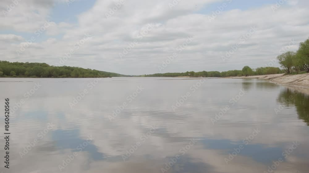 Reflection of blue sky with clouds in river water surface.