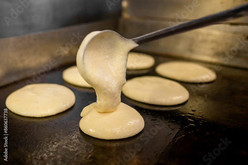фотографія Close-up of pancake batter being poured onto a hot surface
