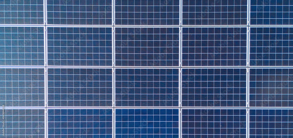 aerial view of solar panels on solar farm during a sunny day. modern photovoltaic solar battery panels. Renewable energy concept aerial view of solar panels on solar farm during a sunny day. modern photovoltaic solar battery panels. Renewable energy concept