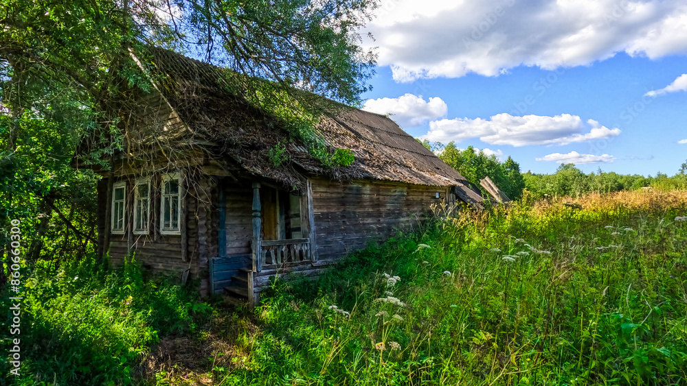 Old wooden house in the village on a sunny summer day Old wooden house in the village on a sunny summer day