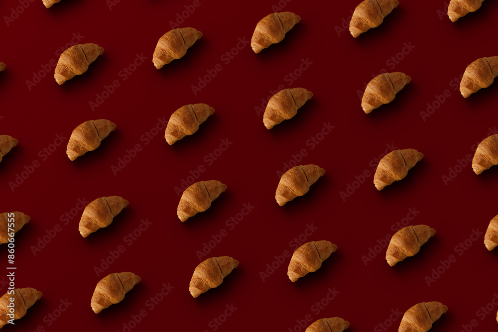 Pattern of baked croissants with a red background. Delicious pastries Pattern of baked croissants with a red background. Delicious pastries