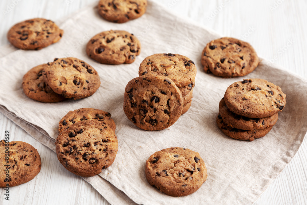 Homemade Gooey Chocolate Chip Cookies on a white wooden background, side view. Homemade Gooey Chocolate Chip Cookies on a white wooden background, side view.
