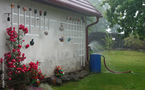 Water flows into a barrel . How to collect rain water  .