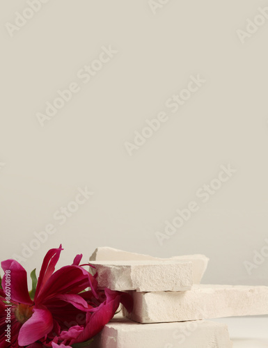 Stones platform podium and flower on beige background. Minimal empty display product presentation scene. photo