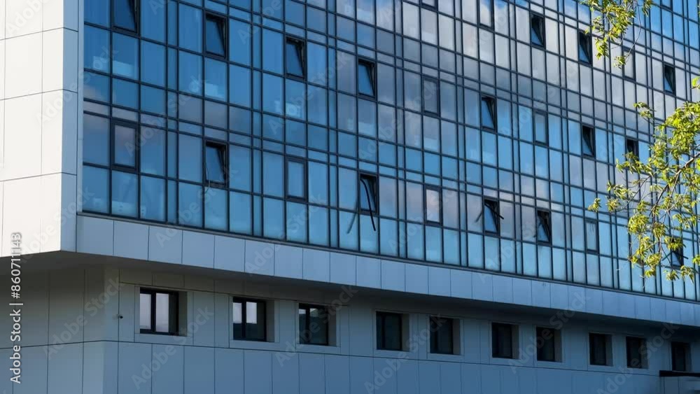 Sunset Illuminates Modern Hospital Building: Expansive View of Glass-Walled Healthcare Facility Sunset Illuminates Modern Hospital Building: Expansive View of Glass-Walled Healthcare Facility