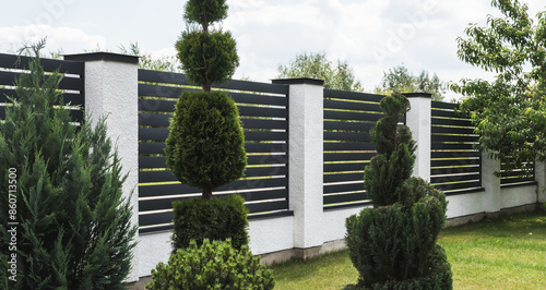 A fragment of a corrugated board fence on a private plot