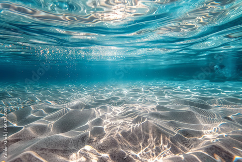 underwater photo of transparent water surface in sea or ocean with sun rays, place for text or inscriptions