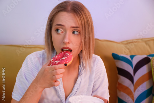 Young woman eating tasty do...