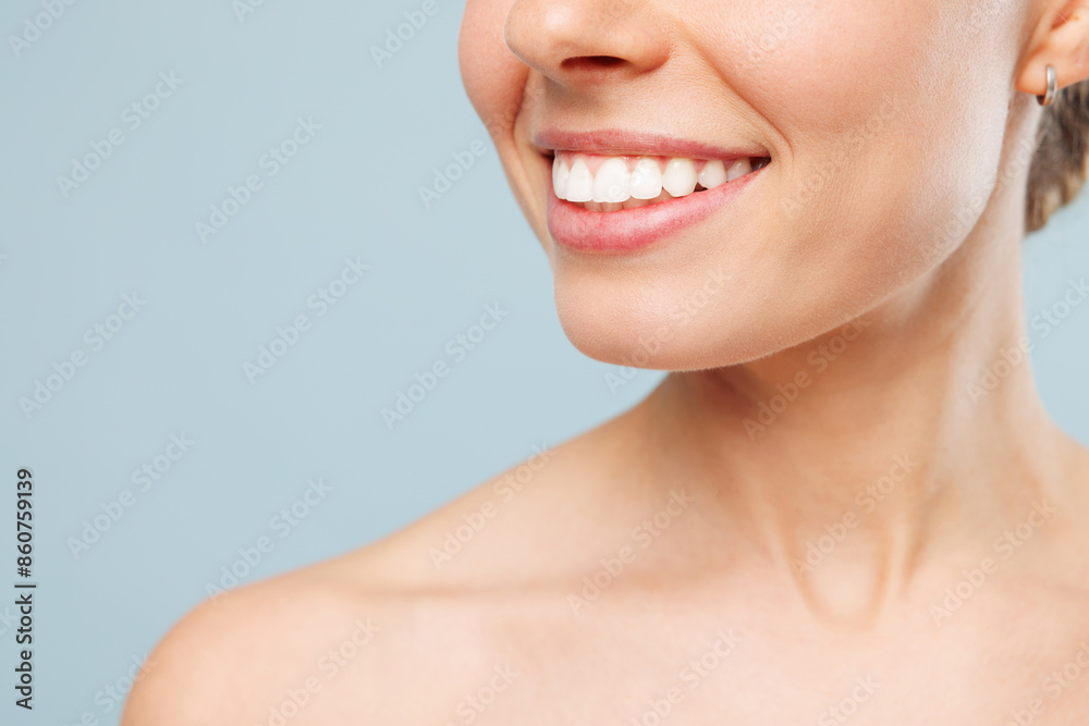 Close up cropped smiling happy half naked topless young woman 20s with nude make up and toothy smile isolated on plain pastel blue color background. Skin care healthcare cosmetic procedures concept. Close up cropped smiling happy half naked topless young woman 20s with nude make up and toothy smile isolated on plain pastel blue color background. Skin care healthcare cosmetic procedures concept.