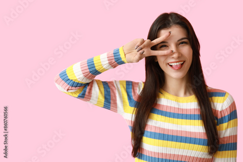 Young woman showing peace s...