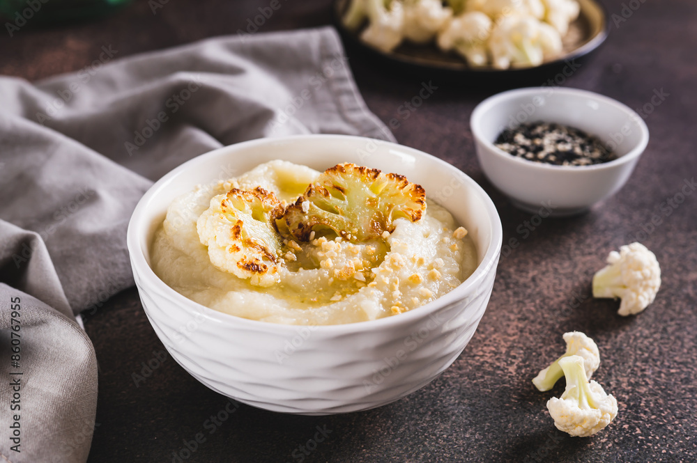 Homemade creamy cauliflower soup in a bowl on the table Homemade creamy cauliflower soup in a bowl on the table