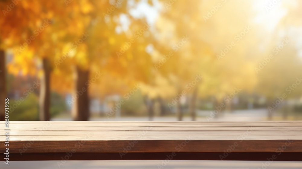 Empty wooden table with a blurred autumn park background, showcasing seasonal foliage and warm sunlight. Empty wooden table with a blurred autumn park background, showcasing seasonal foliage and warm sunlight.
