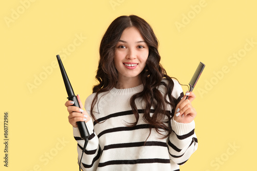 Smiling young woman holding...