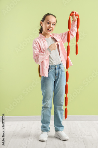 Cute little girl pointing a...
