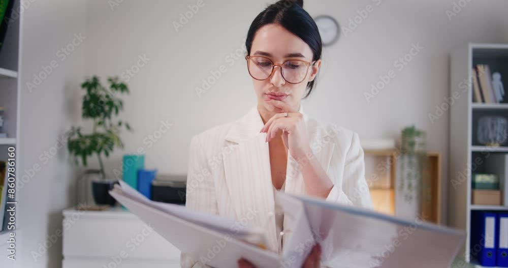 Businesswoman Analyzes Financial Report in Binder