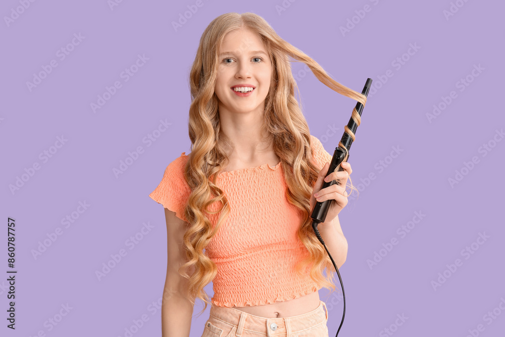 Beautiful young happy woman with curling iron on purple background Beautiful young happy woman with curling iron on purple background