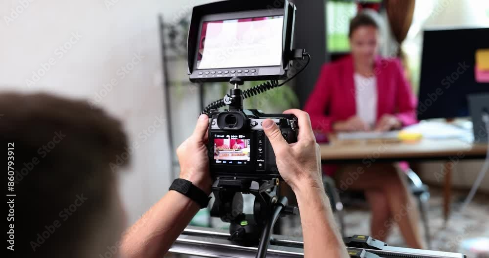 Videographer records video of lady hands typing text using computer keyboard. Woman in pink jacket in front of professional camera in office slow motion Videographer records video of lady hands typing text using computer keyboard. Woman in pink jacket in front of professional camera in office slow motion