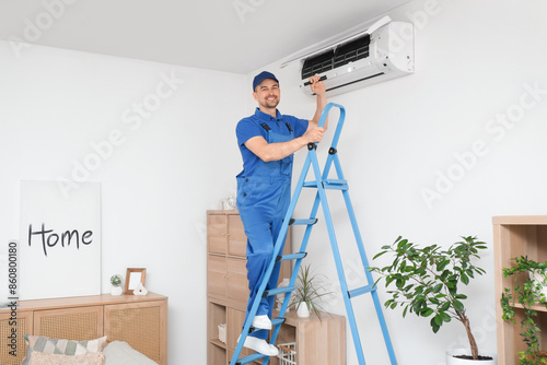 Male technician with flashl...