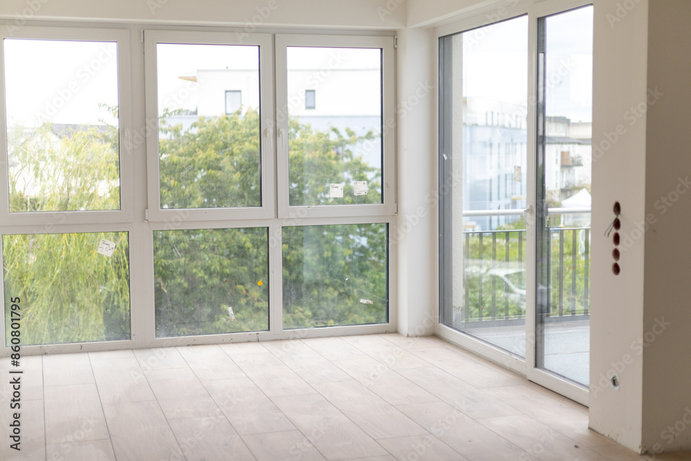 Empty room in new building with unfinished renovation and large windows. Empty room in new building with unfinished renovation and large windows.