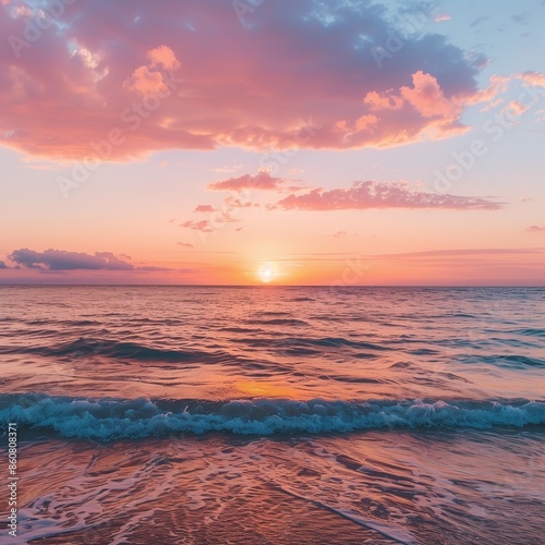 photo of sunset over a calm ocean, with hues of orange, pink, and purple painting the sky