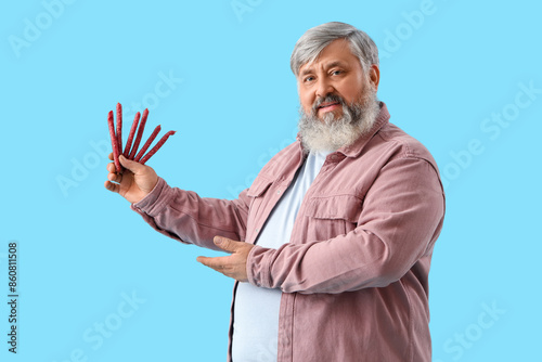 Mature man with tasty sausa...
