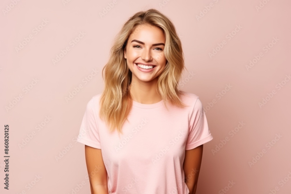 Portrait of a beautiful young blonde woman smiling against pink background. Portrait of a beautiful young blonde woman smiling against pink background.