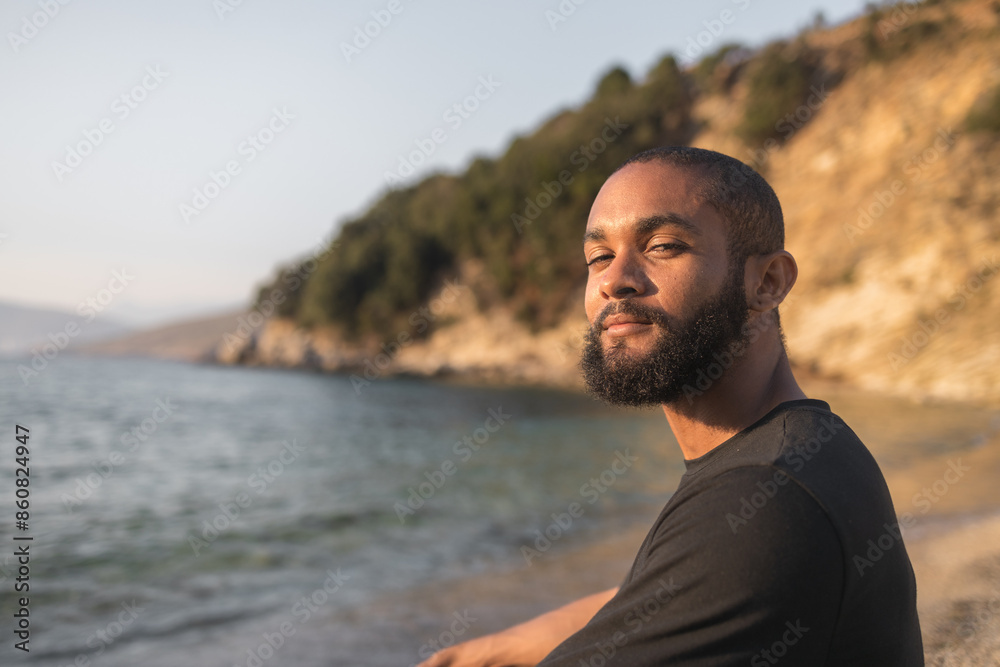 black man sunbathing on the beach in Sarande, Albania. black man sunbathing on the beach in Sarande, Albania.
