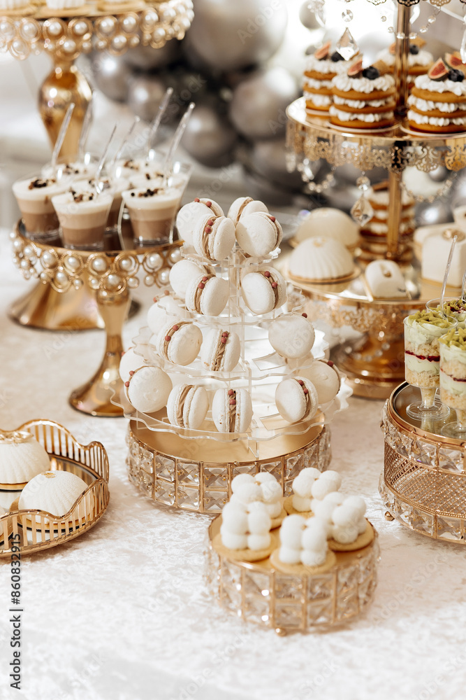 A table full of desserts, including a tower of macarons A table full of desserts, including a tower of macarons