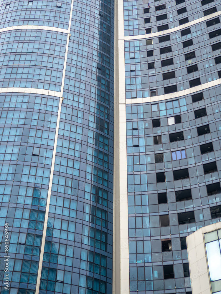 Construction of a modern multi-storey building. Glazed facade. Background from windows. Construction of a modern multi-storey building. Glazed facade. Background from windows.