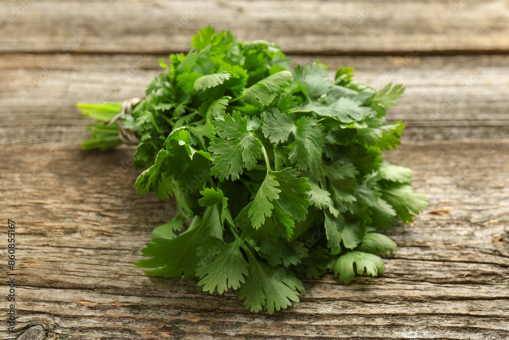 Bunch of fresh coriander on wooden table, closeup Bunch of fresh coriander on wooden table, closeup