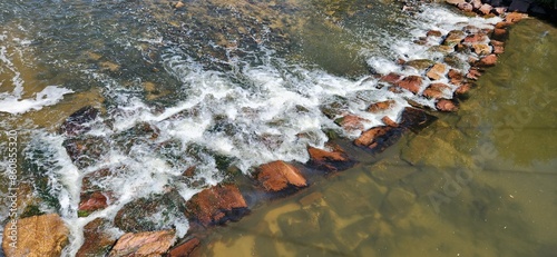 water flowing through rock in the river