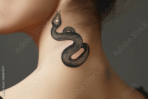 The woman has a snake tattoo on her neck photo