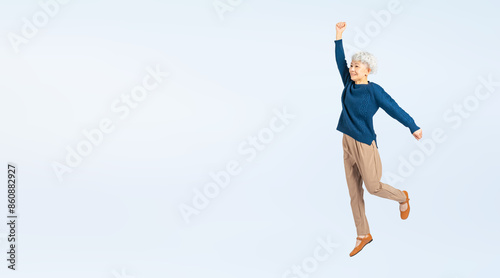 ジャンプするシニア女性の全身写真（切り抜き背景透過PNGも販売しております。作成者リンクから「PNG」で検索してください） © metamorworks