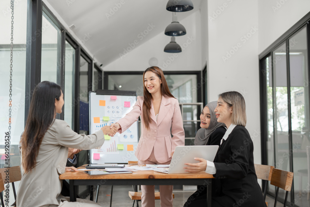 Asian Business Group Chat about graph work Present in meetings, in the office Asian Business Group Chat about graph work Present in meetings, in the office