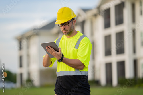 A construction worker in highvisibility gear emphasizes safety and professionalism at a dusty work site photo